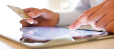 Person making payment using a tablet.