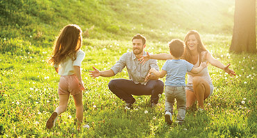 Young family playing outdoors.