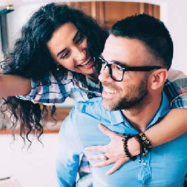 Couple smiling and embracing.