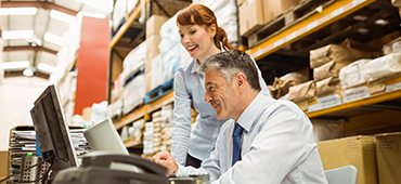 business people looking at computer smiling